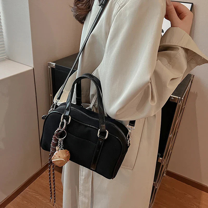 Sac bandoulière Alina en daim noir, chic et pratique, idéal pour transporter vos essentiels avec style.