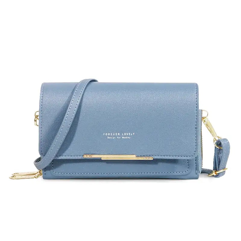 Sac à main CASSIE en cuir synthètique bleu, bandoulière ajustable, avec rabat, compartiments et poches pour organiser vos essentiels avec style et praticité.