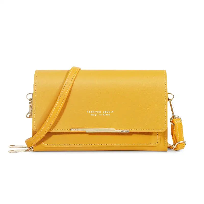 Sac à main CASSIE en cuir synthètique jaune, bandoulière ajustable, avec rabat, compartiments et poches pour organiser vos essentiels avec style et praticité.