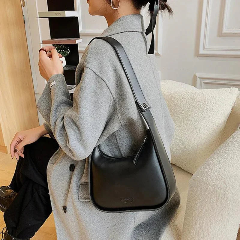 SIRINA - Sac à main bandoulière en cuir souple noir élégant et pratique pour femme, porté en bandoulière